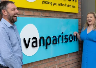 Vanparison Sales Manager and Head of Sales outside of Exeter HQ signage