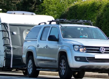 Volkswagen Amarok pick-up towing a caravan on UK road